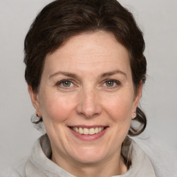 Joyful white adult female with medium  brown hair and grey eyes