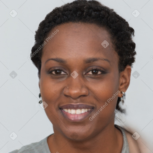 Joyful black young-adult female with short  black hair and brown eyes