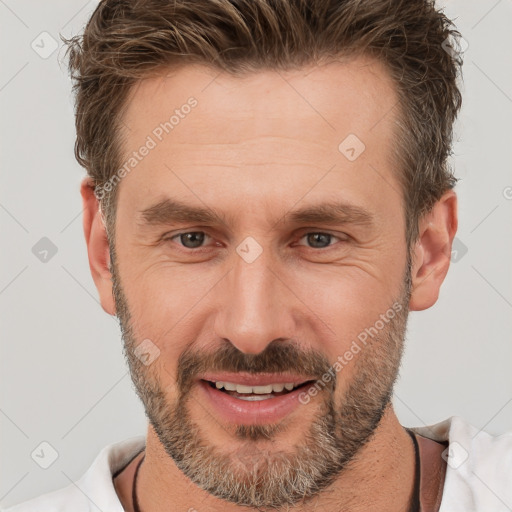 Joyful white adult male with short  brown hair and brown eyes