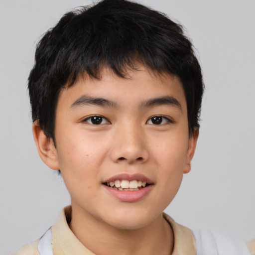 Joyful asian child male with short  brown hair and brown eyes