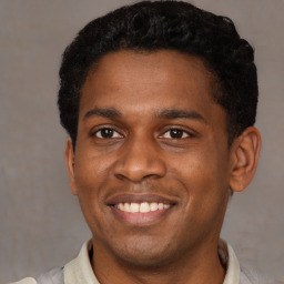 Joyful latino young-adult male with short  brown hair and brown eyes