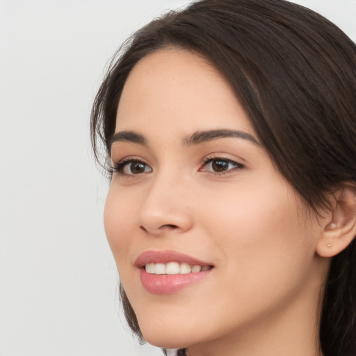 Joyful white young-adult female with long  brown hair and brown eyes