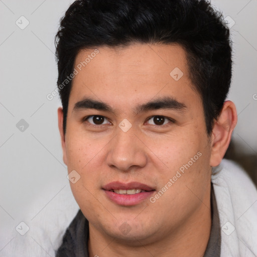 Joyful latino young-adult male with short  brown hair and brown eyes