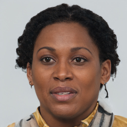 Joyful black adult female with short  brown hair and brown eyes