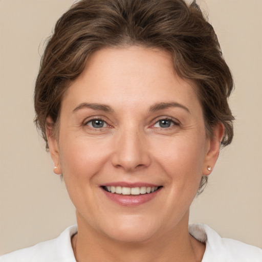 Joyful white adult female with short  brown hair and grey eyes