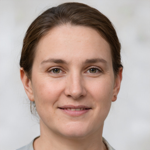 Joyful white adult female with short  brown hair and grey eyes