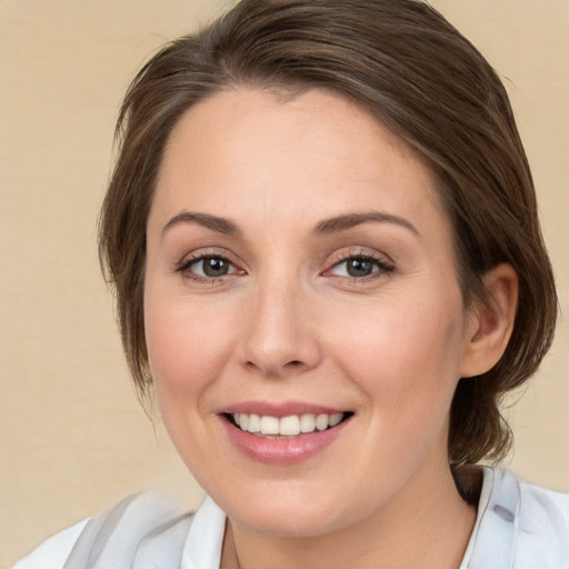 Joyful white young-adult female with medium  brown hair and green eyes