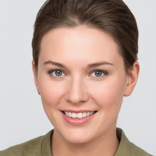 Joyful white young-adult female with short  brown hair and grey eyes