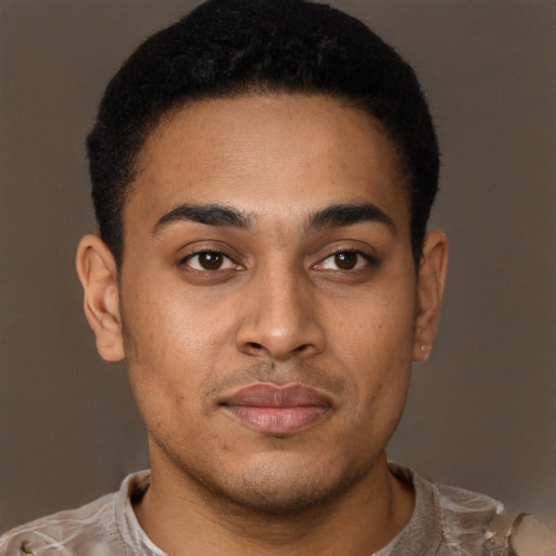 Joyful black young-adult male with short  brown hair and brown eyes
