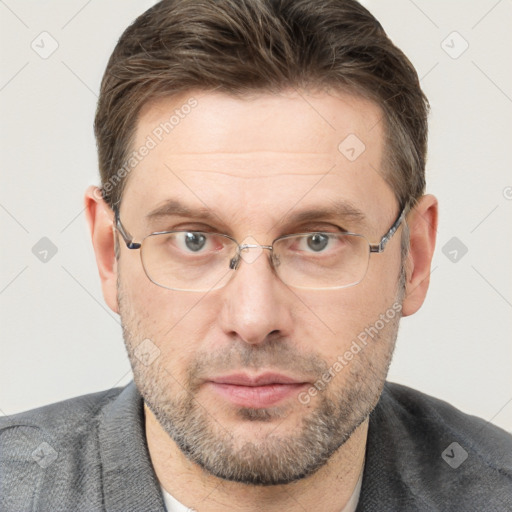 Neutral white adult male with short  brown hair and grey eyes