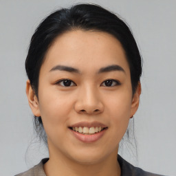 Joyful asian young-adult female with medium  black hair and brown eyes