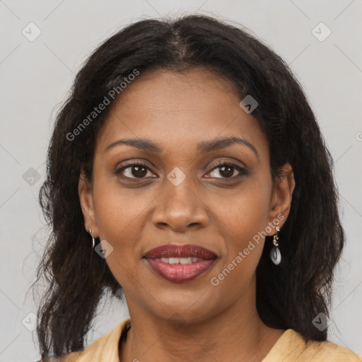 Joyful black adult female with medium  brown hair and brown eyes