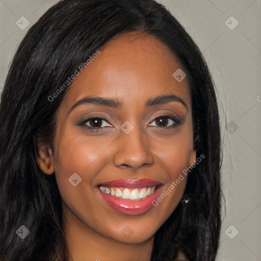 Joyful black young-adult female with long  brown hair and brown eyes