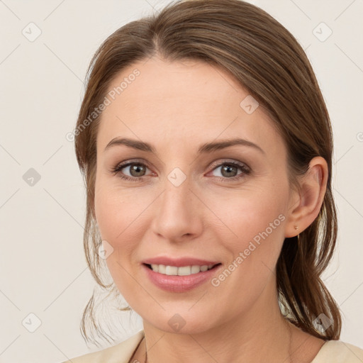 Joyful white young-adult female with medium  brown hair and grey eyes