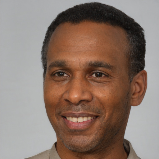 Joyful latino adult male with short  black hair and brown eyes
