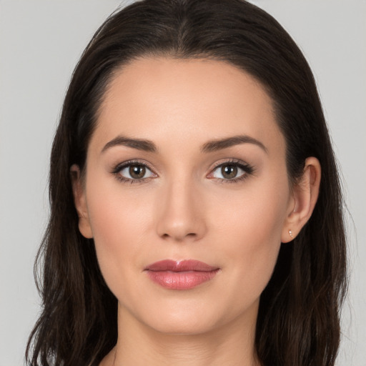 Joyful white young-adult female with long  brown hair and brown eyes