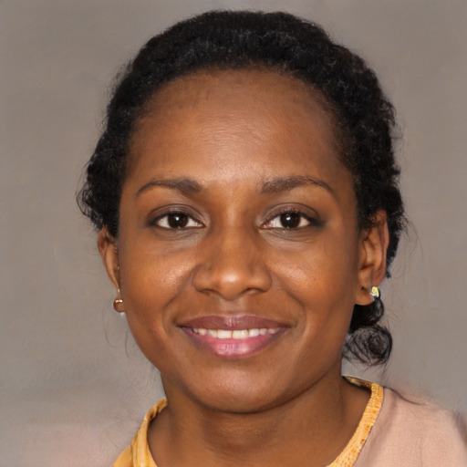 Joyful black young-adult female with short  brown hair and brown eyes