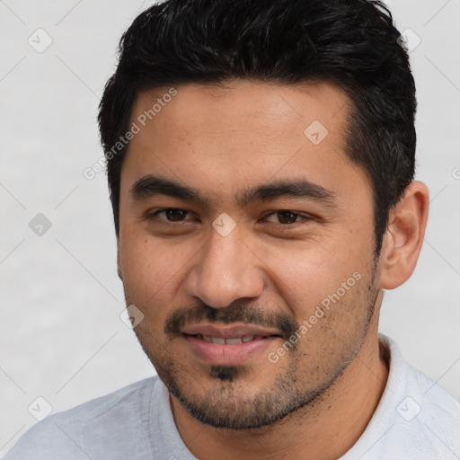 Joyful white young-adult male with short  black hair and brown eyes