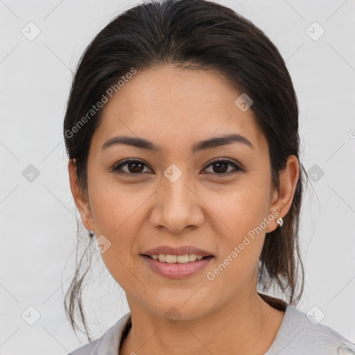 Joyful latino young-adult female with medium  brown hair and brown eyes