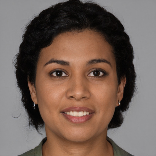 Joyful latino young-adult female with medium  brown hair and brown eyes