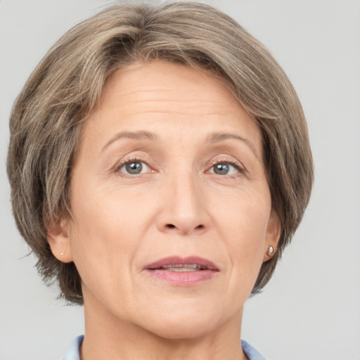 Joyful white adult female with medium  brown hair and grey eyes