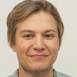 Joyful white adult male with short  brown hair and brown eyes