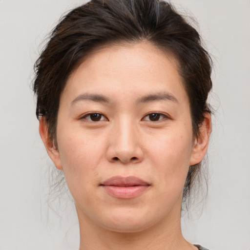 Joyful asian young-adult female with medium  brown hair and brown eyes