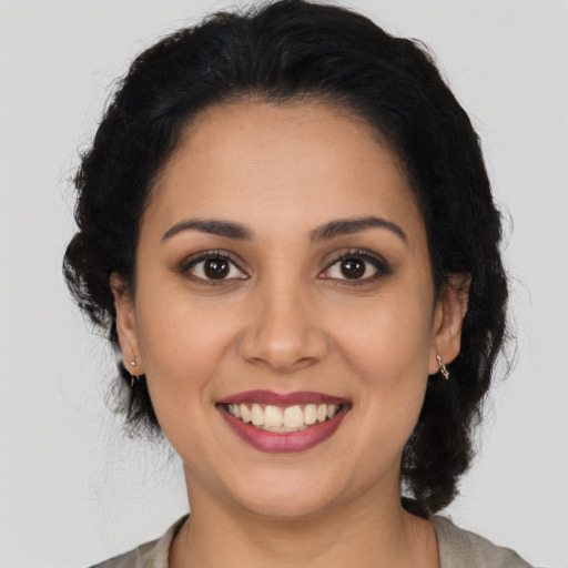 Joyful latino young-adult female with medium  brown hair and brown eyes