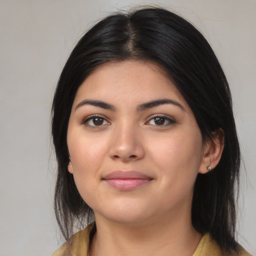 Joyful latino young-adult female with medium  black hair and brown eyes
