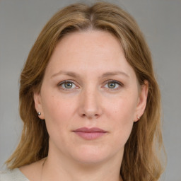 Joyful white adult female with medium  brown hair and grey eyes