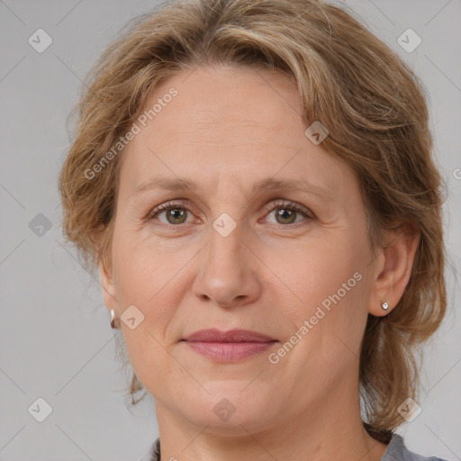 Joyful white adult female with medium  brown hair and grey eyes