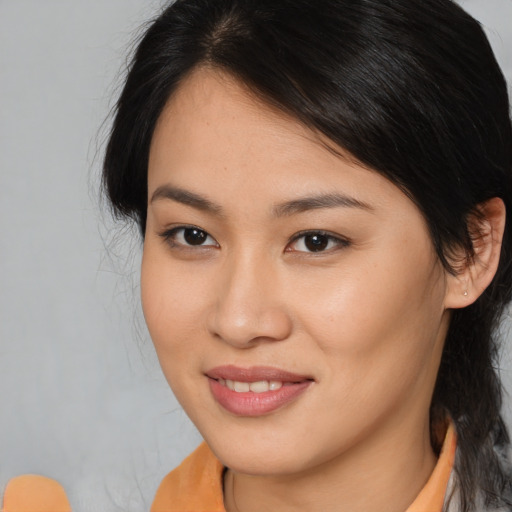 Joyful asian young-adult female with medium  brown hair and brown eyes