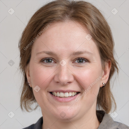 Joyful white adult female with medium  brown hair and grey eyes