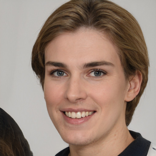 Joyful white young-adult female with medium  brown hair and grey eyes