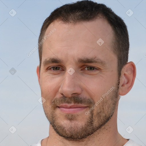 Joyful white adult male with short  brown hair and brown eyes