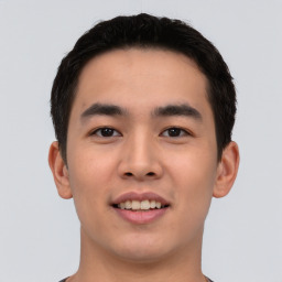 Joyful asian young-adult male with short  black hair and brown eyes