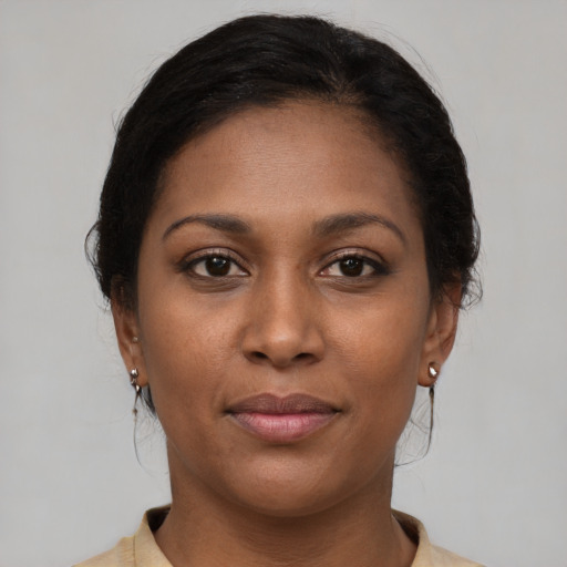 Joyful black young-adult female with medium  brown hair and brown eyes
