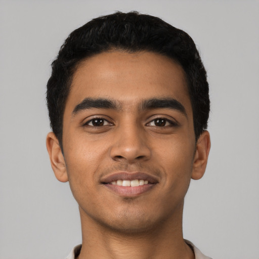 Joyful latino young-adult male with short  black hair and brown eyes