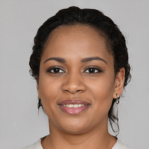 Joyful black young-adult female with medium  black hair and brown eyes