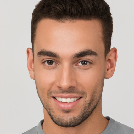 Joyful white young-adult male with short  brown hair and brown eyes