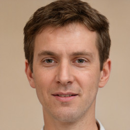 Joyful white adult male with short  brown hair and brown eyes