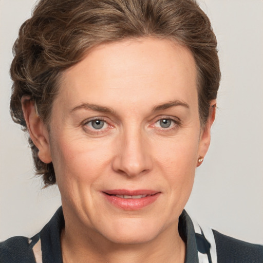 Joyful white adult female with medium  brown hair and grey eyes