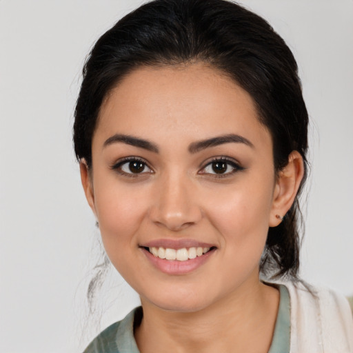 Joyful latino young-adult female with medium  black hair and brown eyes