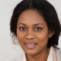 Joyful black young-adult female with long  brown hair and brown eyes