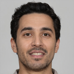Joyful white young-adult male with short  black hair and brown eyes