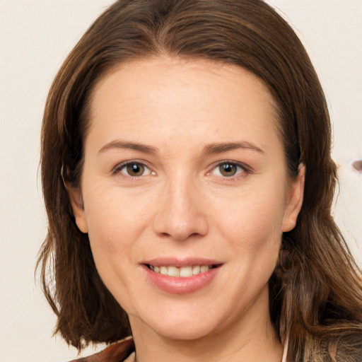 Joyful white adult female with long  brown hair and brown eyes