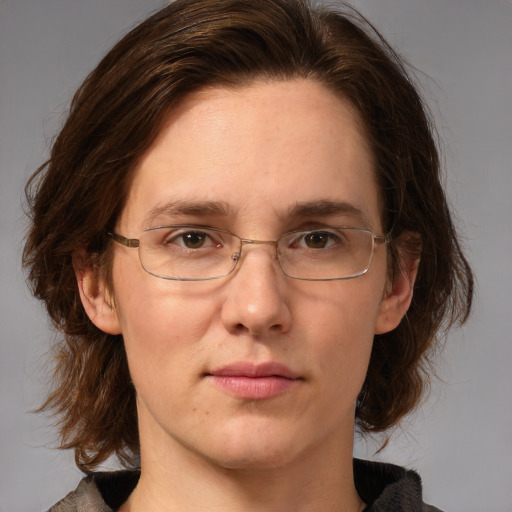 Joyful white adult female with medium  brown hair and green eyes