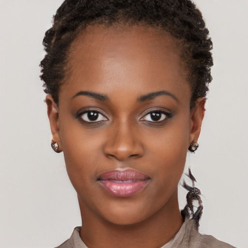 Joyful black young-adult female with short  brown hair and brown eyes