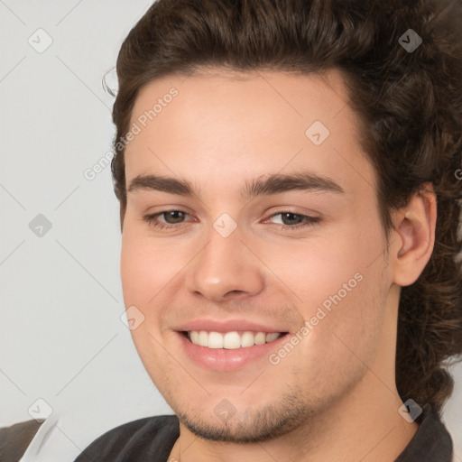 Joyful white young-adult male with medium  brown hair and brown eyes