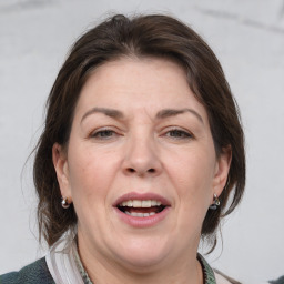 Joyful white adult female with medium  brown hair and grey eyes